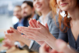 Photo of business people hands applauding at conference